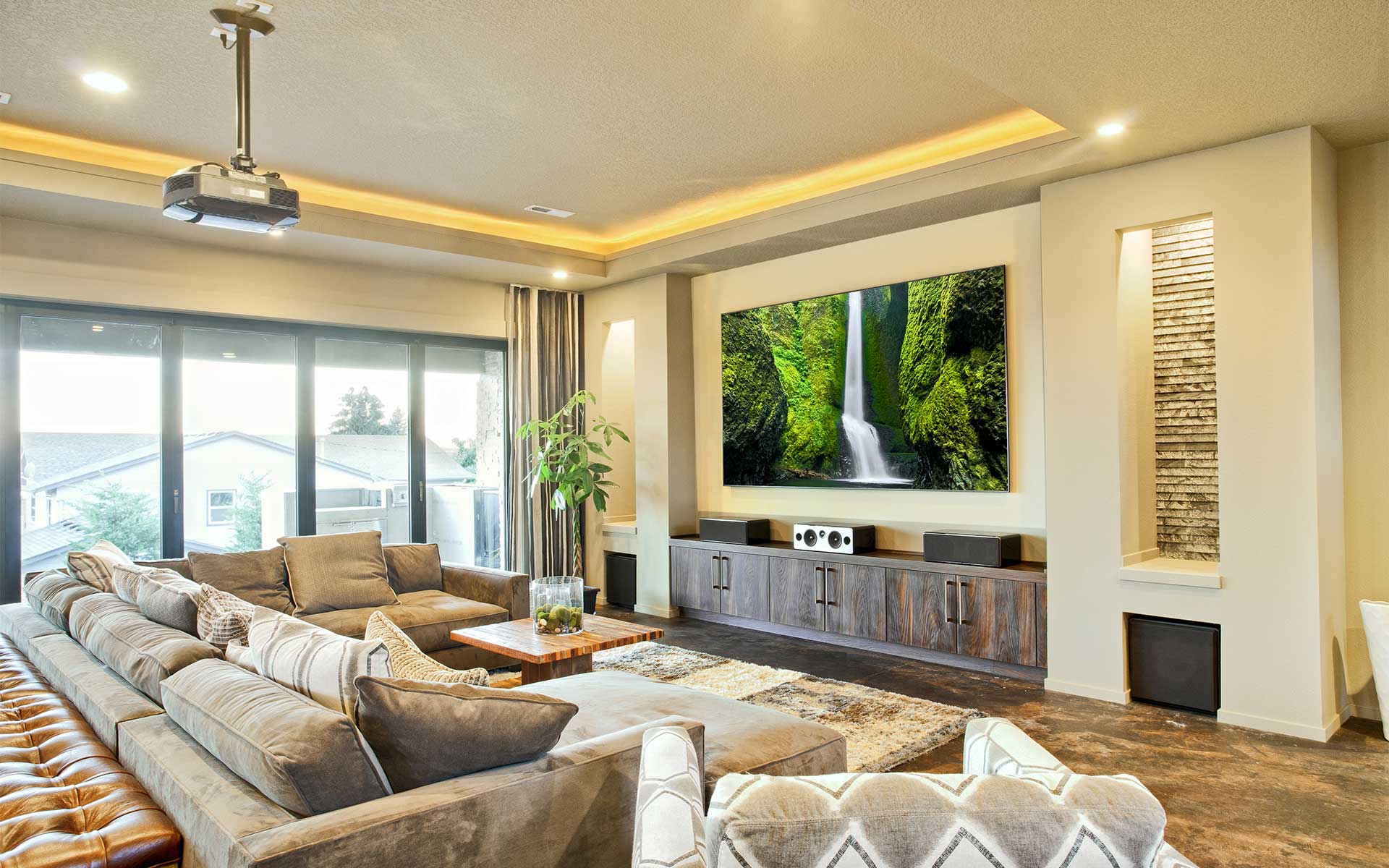 A spacious and sunny, high-end living room in Encino, CA, with a modern TV projector and sound system