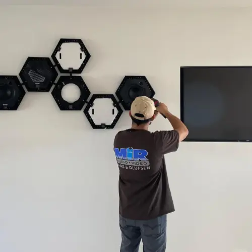 A MIR Audio Video insured AV installer in Los Angeles installs an intricate wall-mounted speaker system inside a home