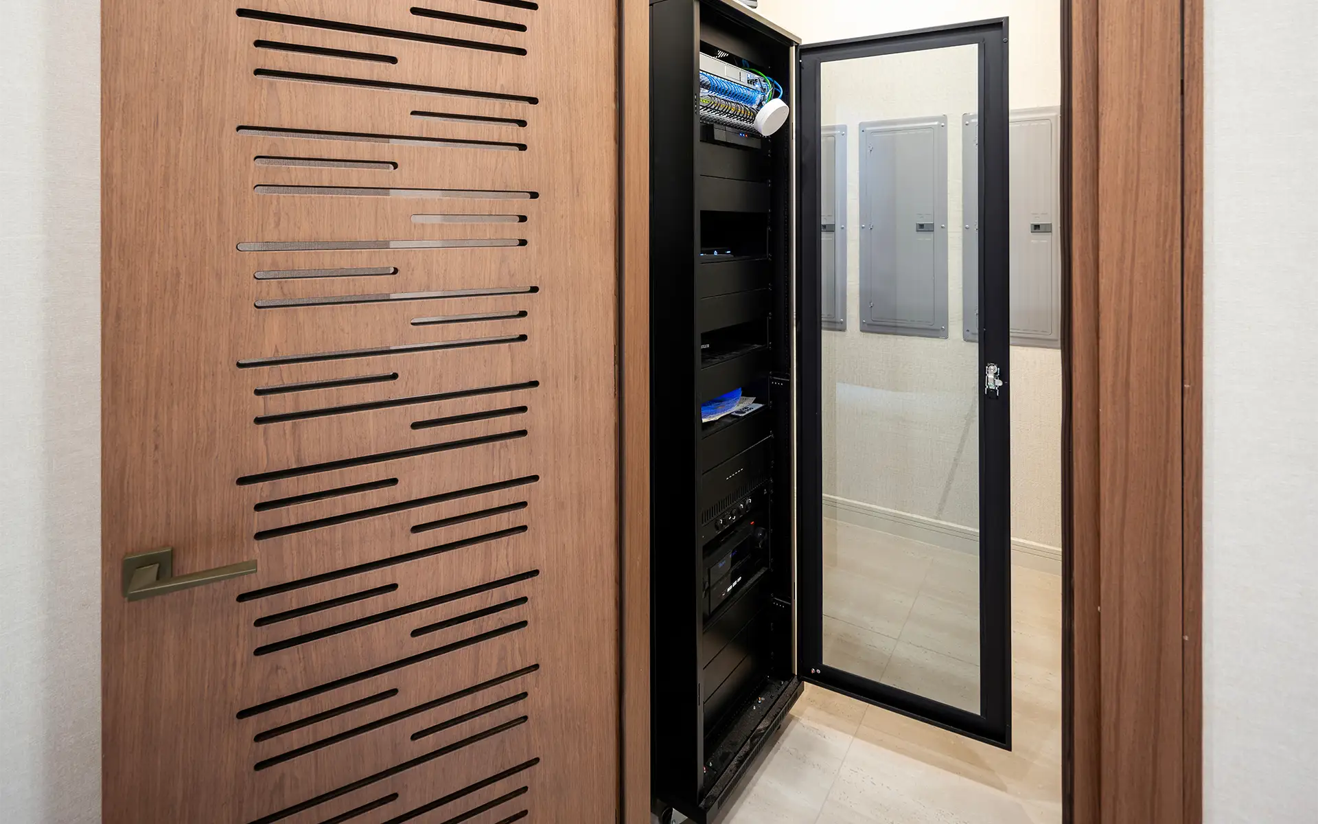 A smart home automation server room in a modern home with the equipment rack door open and ready for home technology maintenance